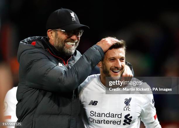 Liverpool manager Jurgen Klopp celebrates with Adam Lallana after the Premier League match at Old Trafford, Manchester.