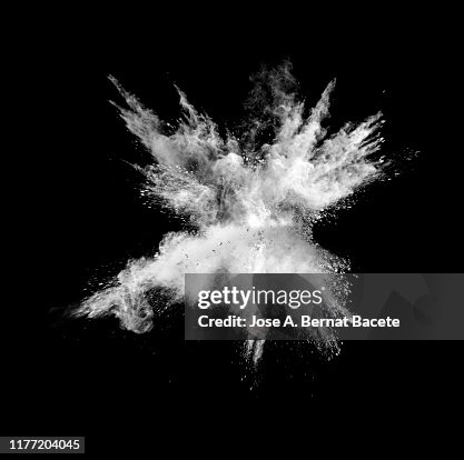 Explosion by an impact of a cloud of particles of powder of white color on a black background. Explosion by an impact of a cloud of particles of powder of white color on a black background.