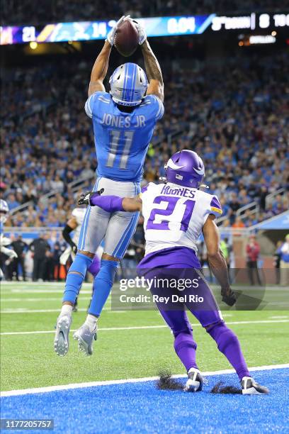 Marvin Jones of the Detroit Lions catches a second quarter touchdown in front of Mike Hughes of the Minnesota Vikings at Ford Field on October 20,...