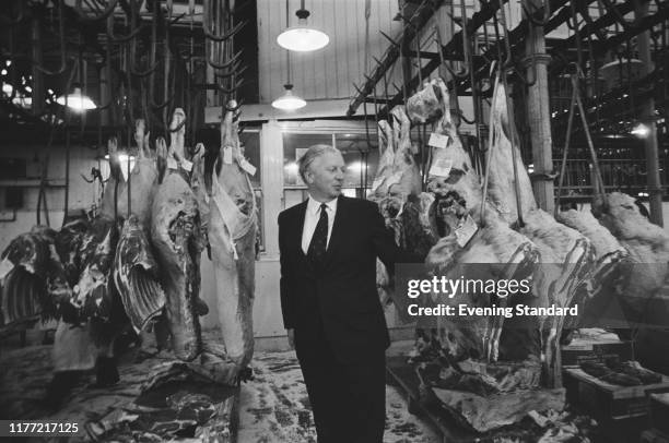 British Conservative Party politician James Prior , Minister of Agriculture, Fisheries and Food, checks labels on sides of beef during a visit to...