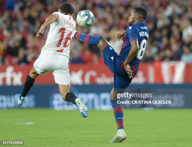 Sevilla's Spanish midfielder Jesus Navas jumps for the ball as Levante's Portuguese forward Hernani Fortes kicks the ball during the Spanish league...