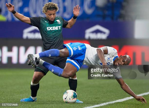 Charles Kabore of FC Dynamo Moscow and Tonny Vilhena of FC Krasnodar vie for the ball during the Russian Premier League match between FC Dynamo...