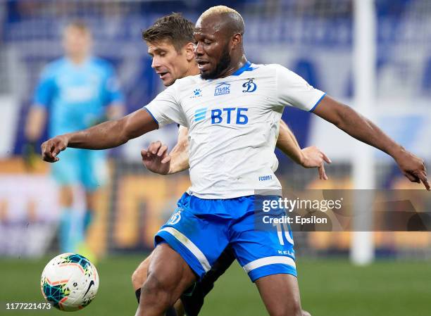 Sylvester Igboun of FC Dynamo Moscow and Alyaksandr Martynovich of FC Krasnodar vie for the ball during the Russian Premier League match between FC...