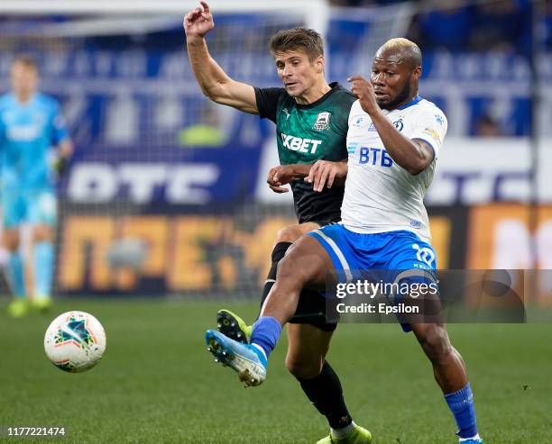 Sylvester Igboun of FC Dynamo Moscow and Alyaksandr Martynovich of FC Krasnodar vie for the ball during the Russian Premier League match between FC...