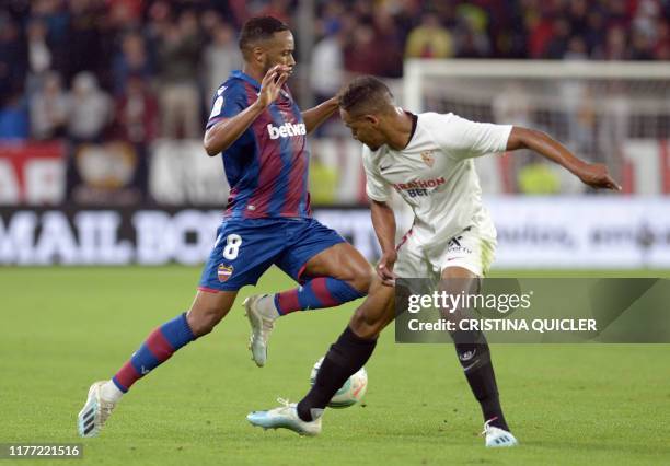 Sevilla's Argentinian midfielder Lucas Ocampos vies with Levante's Portuguese forward Hernani Fortes during the Spanish league football match Sevilla...