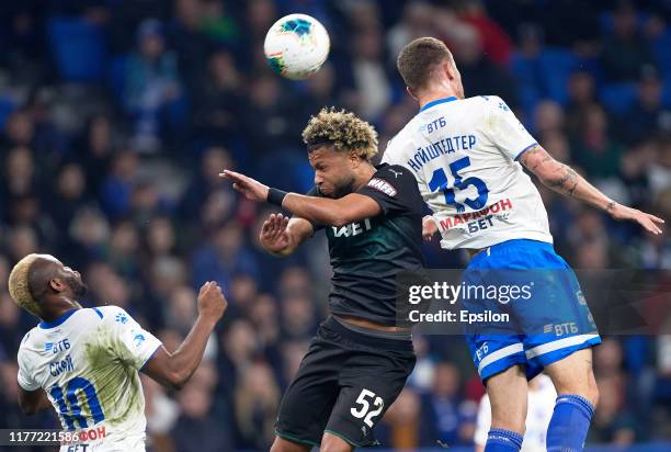 Sylvester Igboun and Roman Noyshtedter of FC Dynamo Moscow and Tonny Vilhena of FC Krasnodar vie for the ball during the Russian Premier League match...