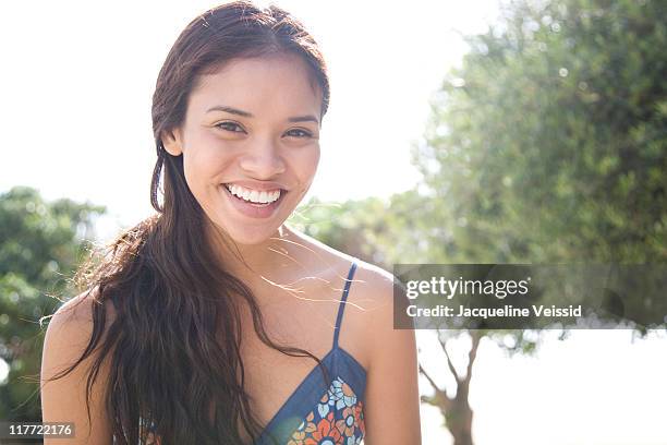 cheerful woman backlit by the sun - filipino ethnicity foto e immagini stock