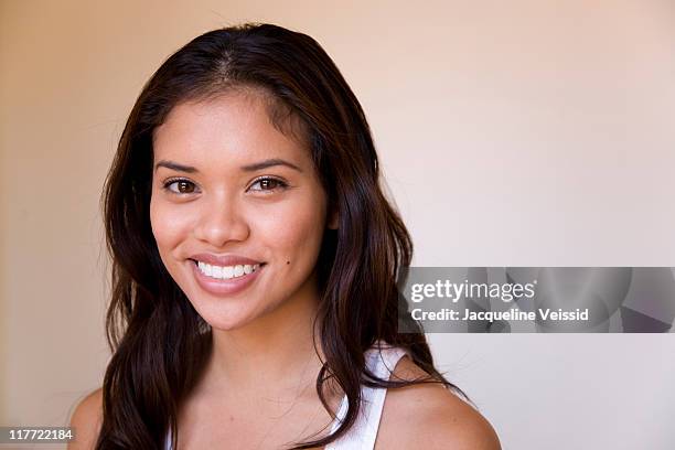 cheerful woman with long hair smiling - filipino ethnicity foto e immagini stock