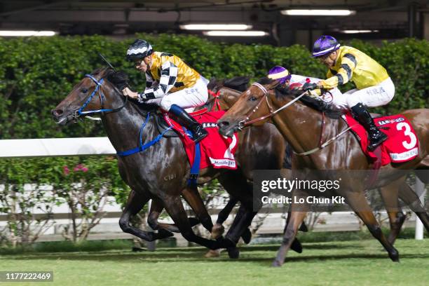 Jockey Chad Schofield riding Telecom Puma wins the Race 7 Community Chest Cup at Happy Valley Racecourse on September 25, 2019 in Hong Kong.