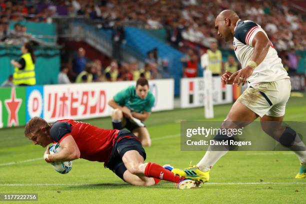 Ruaridh McConnochie of England scores his sides fifth try as Paul Lasike of USA steps on his ankle during the Rugby World Cup 2019 Group C game...