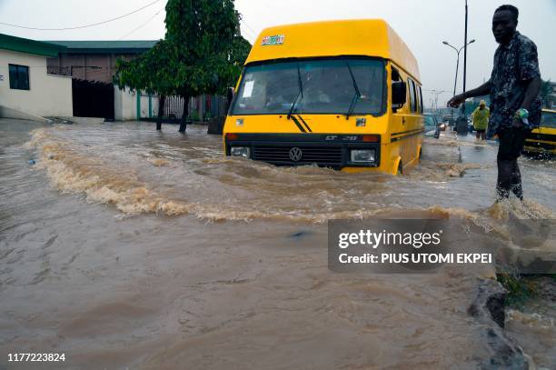 Public transport bus drives in a flooded Agege Motor Road, in the local Government Area of Mushin town, Lagos, on October 20, 2019. - Recent...