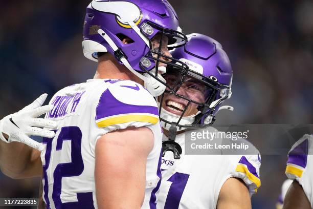 Kyle Rudolph of the Minnesota Vikings celebrates a touchdown with teammate Austin Cutting during the fourth quarter of the game at Ford Field on...
