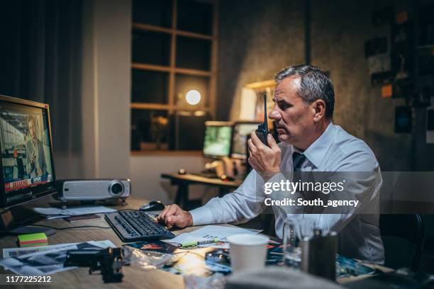 mature detective working late in office - sergeant stock pictures, royalty-free photos & images