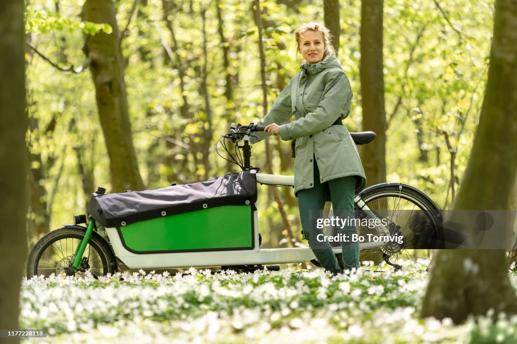 Young woman with her cargo bike