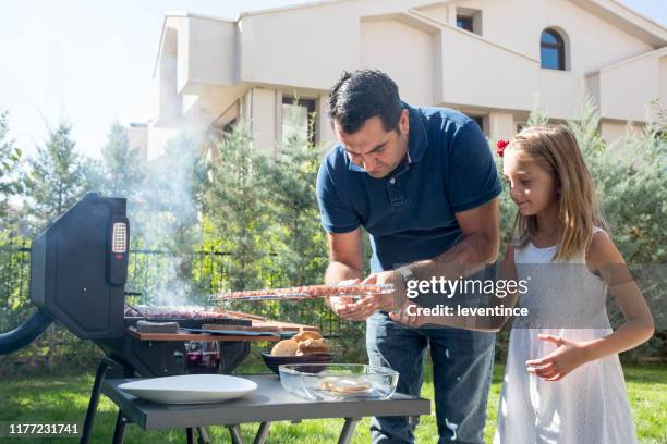 father and daughter on a family barbecue - dad grilling stock pictures, royalty-free photos & images
