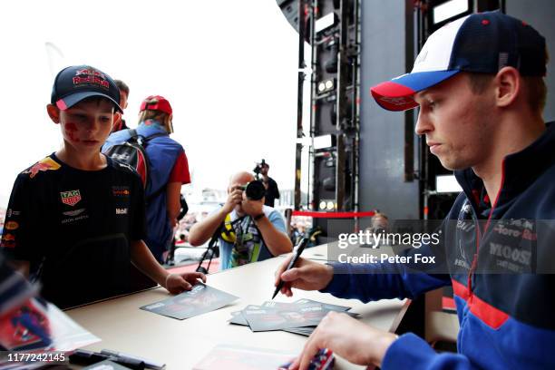 Daniil Kvyat of Russia and Scuderia Toro Rosso signs autographs for fans on the fan stage during previews ahead of the F1 Grand Prix of Russia at...