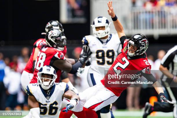 Matt Ryan of the Atlanta Falcons falls after pressure from defender Dante Fowler of the Los Angeles Rams during the first half of a game at...