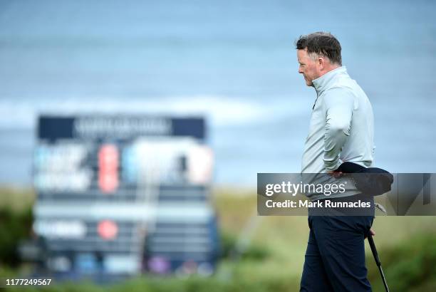 Marcus Fraser of Australia looks at the scoreboard during Day one of the Alfred Dunhill Links Championship at Kingsbarns Golf Links on September 26,...