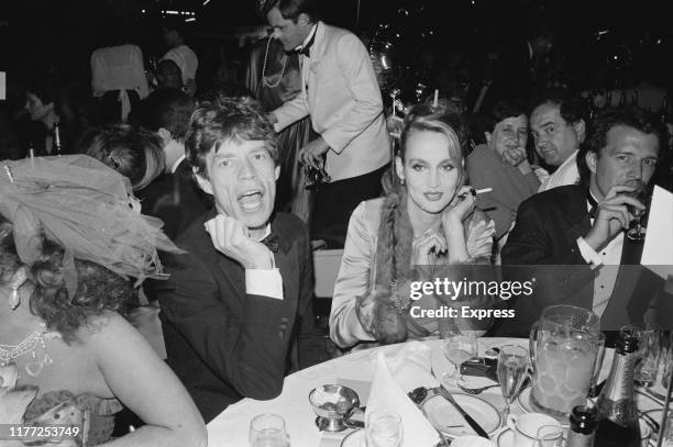 English singer, songwriter, actor, and film producer Mick Jagger and American model and actress Jerry Hall attend the Berkeley Square Ball, London,...