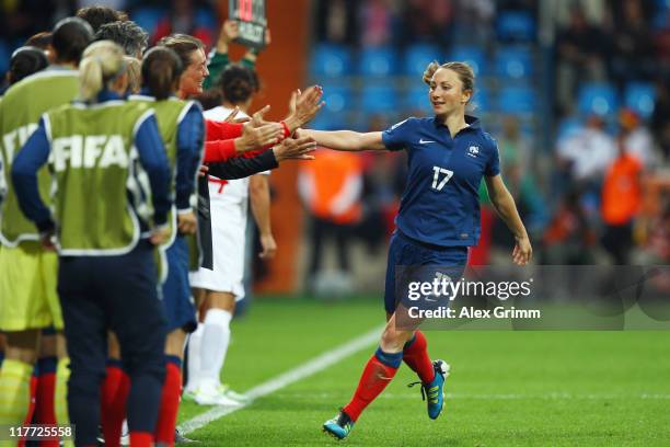 Gaetane Thiney of France celebrates her team's second goal with team mates during the FIFA Women's World Cup 2011 Group A match between Canada and...