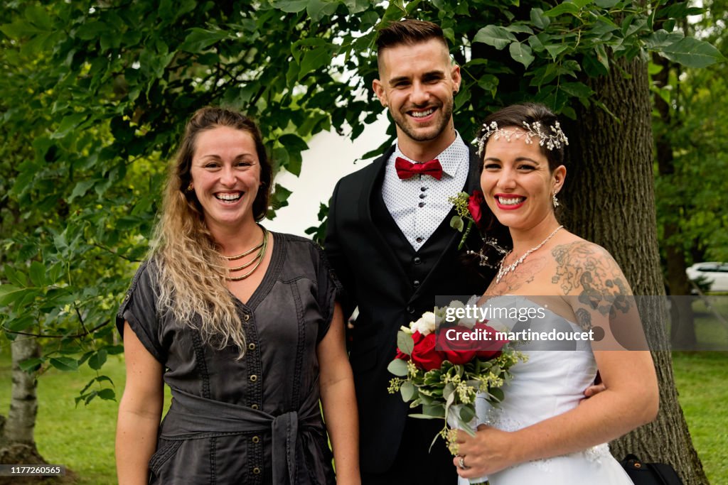 Traditionnal wedding portrait of millennial couple outdoors.