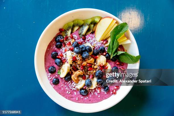 acai bowl with various fruits and berries - chia seed stock-fotos und bilder