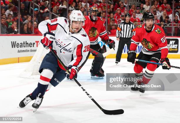 Brendan Leipsic of the Washington Capitals and Erik Gustafsson of the Chicago Blackhawks skate in the first period at the United Center on October...