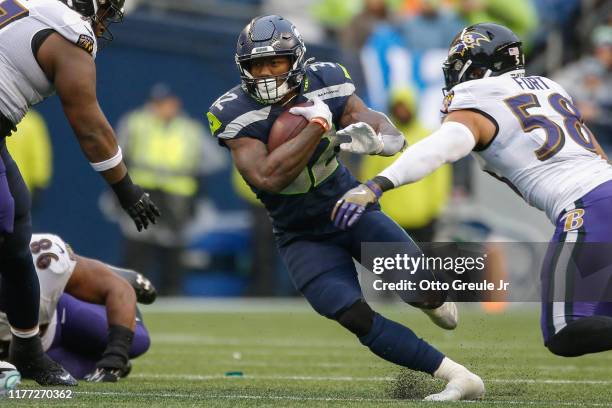 Running back Chris Carson of the Seattle Seahawks rushes against the Baltimore Ravens at CenturyLink Field on October 20, 2019 in Seattle, Washington.