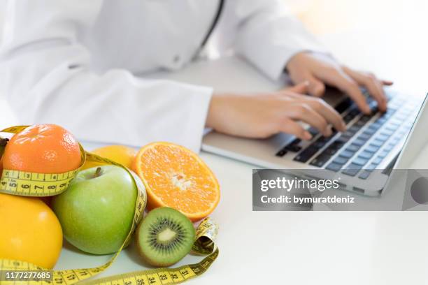 female nutritionist working - nutritionist stock pictures, royalty-free photos & images