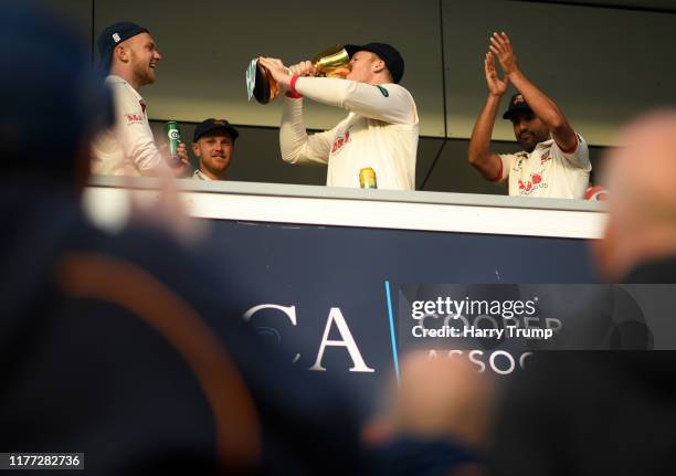 Simon Harmer of Essex drinks from the County Championship Trophy during Day Four of the Specsavers County Championship Division One match between...