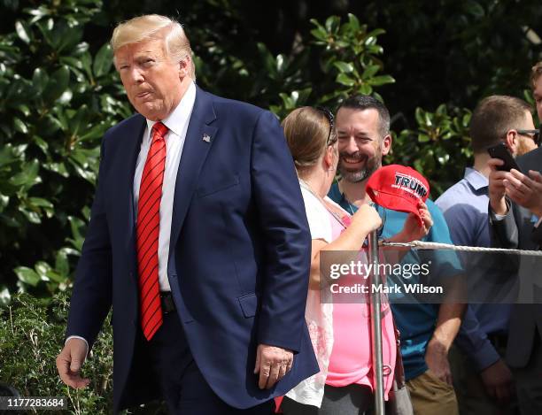 President Donald Trump walks away after greeting onlookers as he returns to the White House after attending the United Nations General Assembly on...