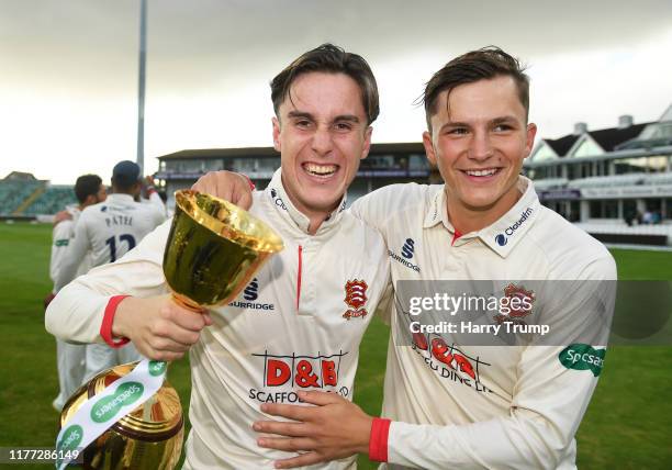 Will Buttleman and Michael Pepper of Essex ce lebrate with the Championship Trophyduring Day Four of the Specsavers County Championship Division One...