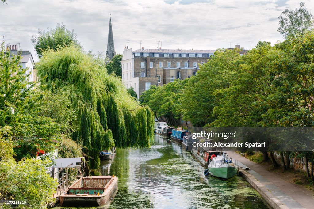 Canal with boats and residential buildings in Camden Town, London, UK