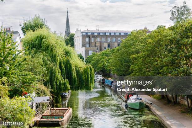 canal with boats and residential buildings in camden town, london, uk - regents canal stock pictures, royalty-free photos & images