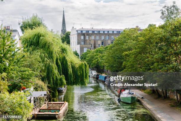 canal with boats and residential buildings in camden town, london, uk - idyllic house stock pictures, royalty-free photos & images