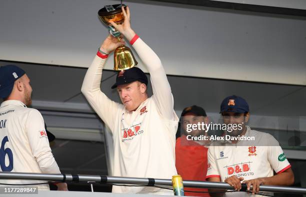 Simon Harmer of Essex celebrates with the County Championship Trophy during Day Four of the Specsavers County Championship Division One match between...