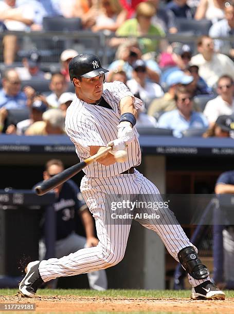 Mark Teixeira of the New York Yankees hits a solo home run in the third inning against the Milwaukee Brewers during their game on June 30, 2011 at...