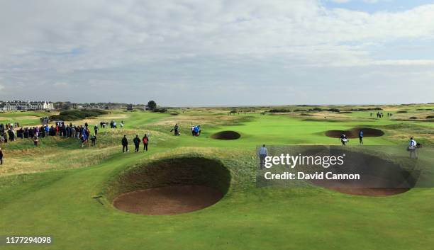 Johann Rupert the Chairman and CEO of Richemont group walks between the 'Spectacles Bunkers' after playing his third shot on the 14th hole during the...