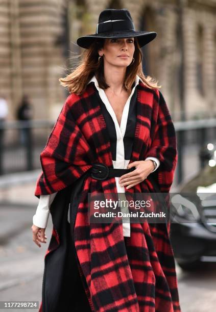 Guest is seen wearing a red and black flannel coat and a black hat outside the Redemption show during Paris Fashion Week SS20 on September 26, 2019...