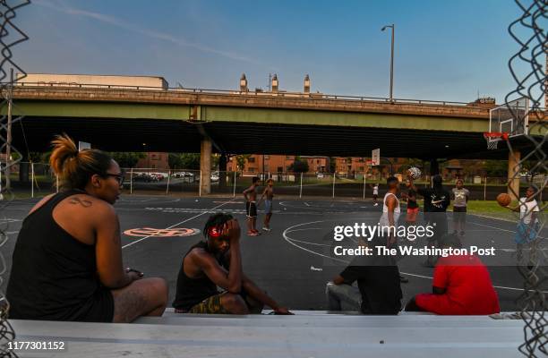 Kids play basketball at Wilson Park near where highway I-81 slices through the public housing complex called Pioneer Homes in the south side of the...