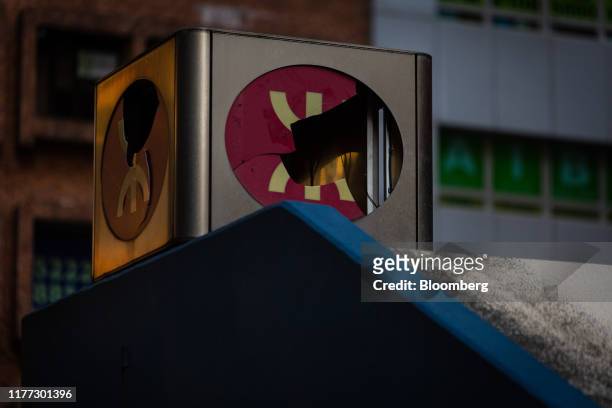 The MTR Corp. Logo sits damaged atop an entrance to a station during a protest in the Yau Ma Tei district of Hong Kong, China, on Sunday, Oct. 20,...