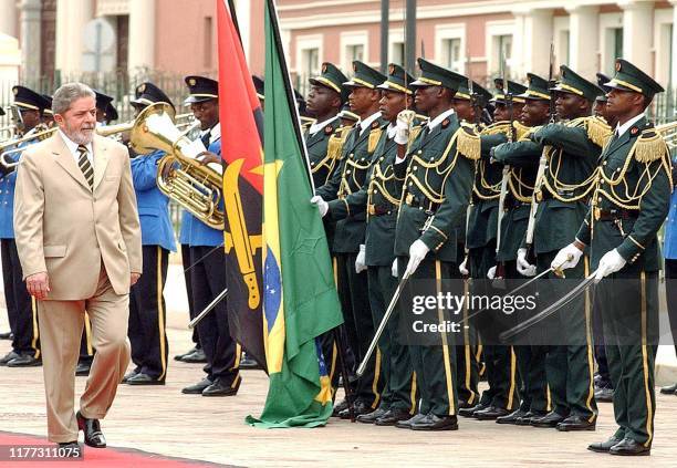 Brazilian President Luiz Inacio Lula da Silva reviews a honor guard during the arrival ceremony 03 November 2003, at Luanda, Angola, as part of an...