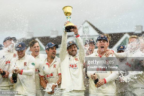 Ryan Ten Doeschate of Essex lifts the County Championship Trophy during Day Four of the Specsavers County Championship Division One match between...