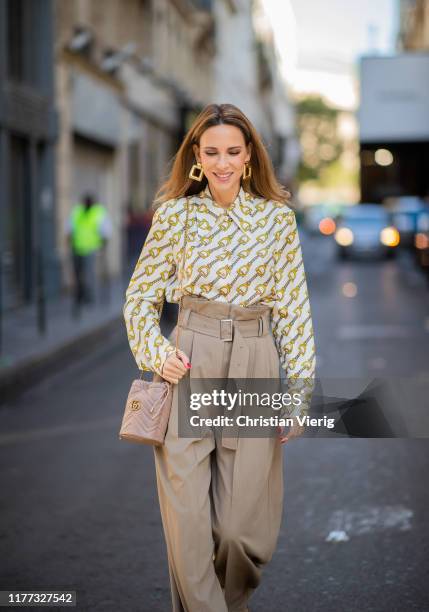 Alexandra Lapp is seen wearing printed Gucci blouse with oversized collar, beige Burberry paperbag pants with a high waist and broad belt detail, GG...