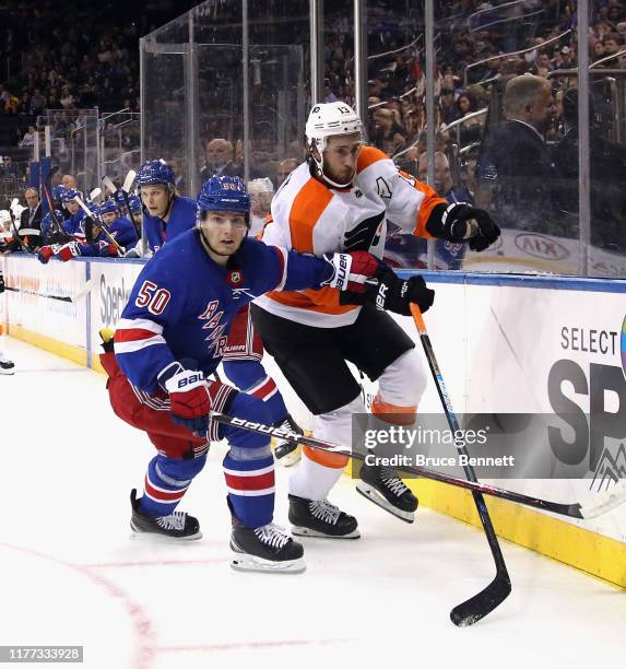 Kevin Hayes of the Philadelphia Flyers attempts to move past Lias Andersson of the New York Rangers during the first period during a preseason game...