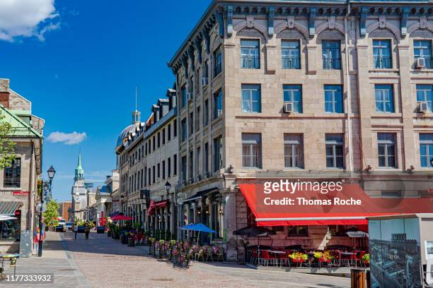 a city street in old town montreal - montréal stock pictures, royalty-free photos & images