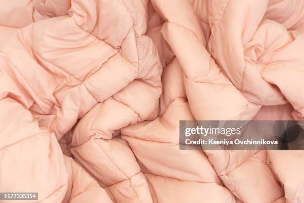 down jacket fabric background, pink puffer jacket texture - down feather stock pictures, royalty-free photos & images