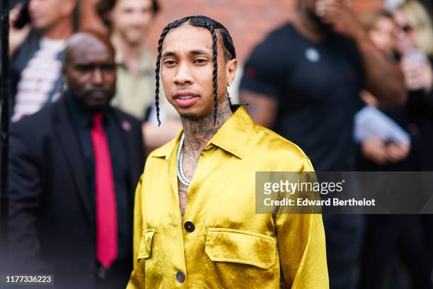 Tyga wears a yellow shiny shirt, tattoos, a necklace, outside Ann Demeulemeester, during Paris Fashion Week - Womenswear Spring Summer 2020 on...