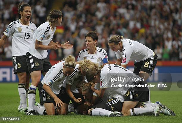 Simone Laudehr of Germany celebrates her first goal with teammates during the FIFA Women's World Cup 2011 Group A match between Germany and Nigeria...