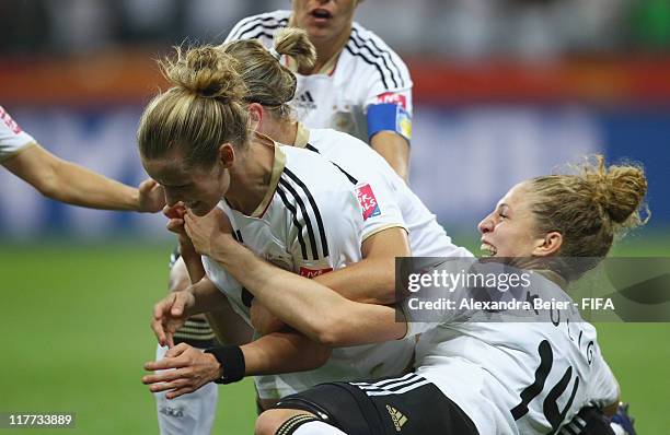 Simone Laudehr of Germany celebrates her first goal with teammate Kim Kulig during the FIFA Women's World Cup 2011 Group A match between Germany and...